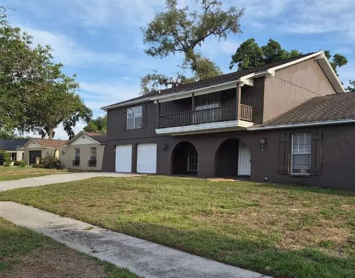 After: an overgrown front lawn cut, edged and cleared, a LoLo Lawncare job in the Tampa area