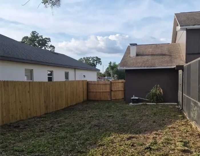After: a patchy backyard cut down to the fence line, a LoLo Lawncare job in the Tampa area