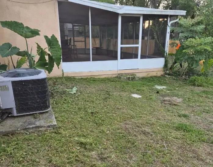 After: a back lawn by the ac and screen room, cut and cleaned, a LoLo Lawncare job in the Tampa area
